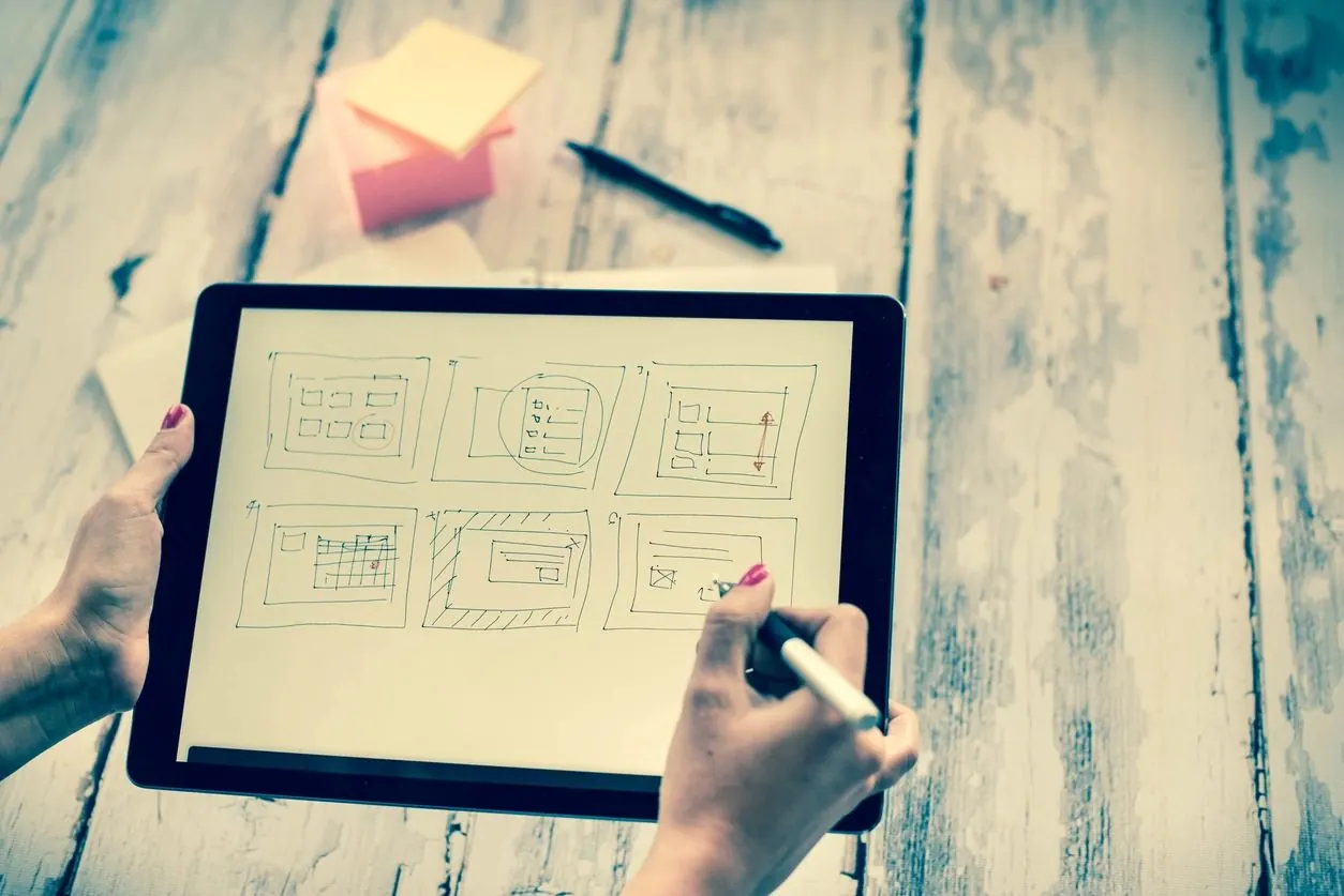 A person mapping a digital strategy on a tablet